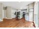 View of the kitchen with light blue cabinets, stainless appliances, island, and hardwood floors at 5741 Stonekirk Walk Northwest, Acworth, GA 30101