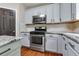 Kitchen with granite counters, stainless gas range, and subway tile backsplash at 5741 Stonekirk Walk Northwest, Acworth, GA 30101