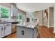Kitchen with granite island, stainless dishwasher, and view to staircase at 5741 Stonekirk Walk Northwest, Acworth, GA 30101