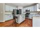 Kitchen with granite counters, stainless appliances, island with breakfast bar, and hardwood floors at 5741 Stonekirk Walk Northwest, Acworth, GA 30101
