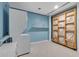 Bright laundry room with white appliances, blue walls, shelving and a rolling clothes rack at 5741 Stonekirk Walk Northwest, Acworth, GA 30101