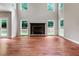 Bright and airy living room with hardwood floors, boasting a fireplace and large windows for ample natural light at 5741 Stonekirk Walk Northwest, Acworth, GA 30101