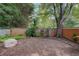 Large backyard area featuring a wood fence, mature trees, and level ground at 834 Lake Hollow Sw Blvd, Marietta, GA 30064