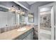 Bathroom features stylish fixtures, unique mirror, and a tub with marble tile surround at 834 Lake Hollow Sw Blvd, Marietta, GA 30064