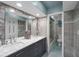 Modern bathroom with double sinks, granite countertops, and a tiled shower at 834 Lake Hollow Sw Blvd, Marietta, GA 30064