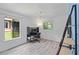 Bright bedroom with two windows, hardwood floors, and an adaptable shelving unit at 834 Lake Hollow Sw Blvd, Marietta, GA 30064