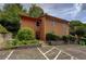 Two-story home with a brown exterior, neatly landscaped front, and convenient parking at 834 Lake Hollow Sw Blvd, Marietta, GA 30064