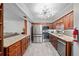Well-lit kitchen boasts granite countertops, stainless appliances, and ample storage in wood cabinetry at 834 Lake Hollow Sw Blvd, Marietta, GA 30064