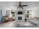 Cozy living room features fireplace, ceiling fan, hardwood floors, and natural light at 834 Lake Hollow Sw Blvd, Marietta, GA 30064