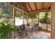 Charming screened patio area with comfortable seating and tranquil outdoor views at 834 Lake Hollow Sw Blvd, Marietta, GA 30064