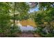 Picturesque view of a pond surrounded by lush green trees, offering a peaceful and natural setting at 834 Lake Hollow Sw Blvd, Marietta, GA 30064