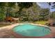 Relaxing community pool with ample seating, a covered patio, and mature trees offering plenty of shade at 834 Lake Hollow Sw Blvd, Marietta, GA 30064