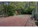 Community tennis court surrounded by trees and fencing at 834 Lake Hollow Sw Blvd, Marietta, GA 30064