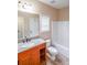Bright bathroom featuring granite countertop and white tiled bathtub at 1057 Cotton Oak Dr, Lawrenceville, GA 30045