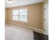 Bedroom with neutral carpet, blinds and paint with a closet door at 1057 Cotton Oak Dr, Lawrenceville, GA 30045