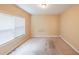 Bedroom with natural light from a window with neutral walls and carpet at 1057 Cotton Oak Dr, Lawrenceville, GA 30045