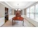 Bright dining room with elegant chandelier, large window and white wainscoting at 1057 Cotton Oak Dr, Lawrenceville, GA 30045