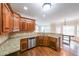 Well-lit kitchen with stainless steel appliances, granite countertops and hardwood floors at 1057 Cotton Oak Dr, Lawrenceville, GA 30045