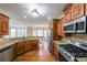 Spacious kitchen featuring granite countertops, stainless steel appliances, and custom wood cabinets at 1057 Cotton Oak Dr, Lawrenceville, GA 30045
