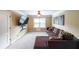 Cozy living room with comfortable sectional couch, tv and natural light from window at 1057 Cotton Oak Dr, Lawrenceville, GA 30045