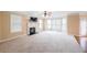 Spacious living room with lots of natural light, fireplace, and neutral carpet at 1057 Cotton Oak Dr, Lawrenceville, GA 30045
