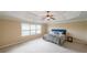 Spacious main bedroom featuring a decorative ceiling, ceiling fan, and large window at 1057 Cotton Oak Dr, Lawrenceville, GA 30045