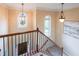 Beautiful staircase with wrought iron railing, decorative windows and entry door view at 1057 Cotton Oak Dr, Lawrenceville, GA 30045