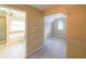 A look through the walk-in closet with shelving, leading to the bathroom with a tub and shower at 1057 Cotton Oak Dr, Lawrenceville, GA 30045