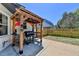 Backyard grilling area with covered pergola and sunny concrete patio at 1807 N Chestnut Grove Dr, Marietta, GA 30066