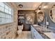 Stylish bathroom featuring double sinks with granite countertops and decorative wallpaper at 1807 N Chestnut Grove Dr, Marietta, GA 30066