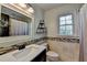 Neat bathroom with decorative mirror, tiled backsplash, and modern fixtures for a comfortable experience at 1807 N Chestnut Grove Dr, Marietta, GA 30066