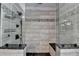 Walk-in shower featuring horizontal tiles with granite benches and dual shower heads at 1807 N Chestnut Grove Dr, Marietta, GA 30066