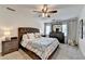 Cozy bedroom with a plush upholstered bed, ceiling fan, and well-lit with natural light at 1807 N Chestnut Grove Dr, Marietta, GA 30066