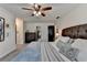 Bedroom view of bed featuring decorative pillows, ceiling fan, and dark wood furnishings at 1807 N Chestnut Grove Dr, Marietta, GA 30066