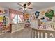 A whimsical bedroom featuring colorful floral wall art and plenty of natural light at 1807 N Chestnut Grove Dr, Marietta, GA 30066
