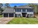 Charming two-story home with painted brick, black shutters, and a well-manicured lawn at 1807 N Chestnut Grove Dr, Marietta, GA 30066