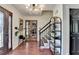 Inviting foyer featuring hardwood floors, modern lighting, staircase, and decorative shelving at 1807 N Chestnut Grove Dr, Marietta, GA 30066