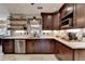 Modern kitchen showcasing dark cabinets, stainless steel appliances, and floating wood shelves at 1807 N Chestnut Grove Dr, Marietta, GA 30066