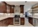 Kitchen showcasing dark cabinets, stainless steel appliances and view to the dining and kitchen areas at 1807 N Chestnut Grove Dr, Marietta, GA 30066