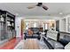 Spacious living room with a view into the dining area, with dark leather sofas, and an area rug at 1807 N Chestnut Grove Dr, Marietta, GA 30066
