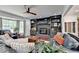 Living room features a fireplace flanked by built-in shelving and a large window for ample natural light at 1807 N Chestnut Grove Dr, Marietta, GA 30066