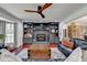 Spacious living area featuring a modern ceiling fan, fireplace with shelving, and ample natural light at 1807 N Chestnut Grove Dr, Marietta, GA 30066