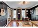Sophisticated home office with dark walls, hardwood floors, and bright windows with white curtains at 1807 N Chestnut Grove Dr, Marietta, GA 30066