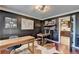 Elegant home office with dark walls, hardwood floors, dual desks and an open doorway to the kitchen at 1807 N Chestnut Grove Dr, Marietta, GA 30066