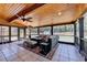 Screened patio with wood ceiling, fan, and comfortable seating area at 1807 N Chestnut Grove Dr, Marietta, GA 30066