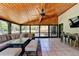 Inviting covered patio with wood ceiling, sectional, dining area, and outdoor lighting at 1807 N Chestnut Grove Dr, Marietta, GA 30066