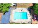 Aerial view of a community pool with a diving board, surrounded by a fence and seating, next to a playground at 1807 N Chestnut Grove Dr, Marietta, GA 30066