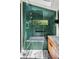 Bathroom featuring marble floors, walk-in glass shower with green tile and a skylight at 261 Ormond Se St, Atlanta, GA 30315