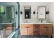 Modern bathroom with double sink vanity and glass enclosed shower at 261 Ormond Se St, Atlanta, GA 30315