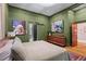 Spacious bedroom featuring earth-tone colored walls, modern decor and a sliding barn door to the bathroom at 261 Ormond Se St, Atlanta, GA 30315